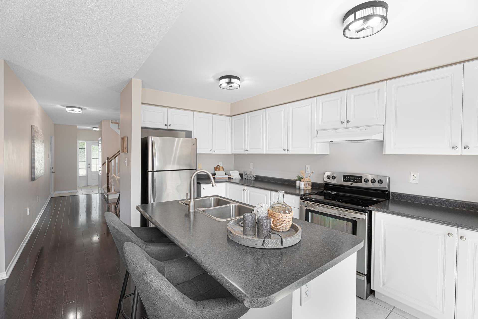 A Kitchen With An Island And A Door To The Deck