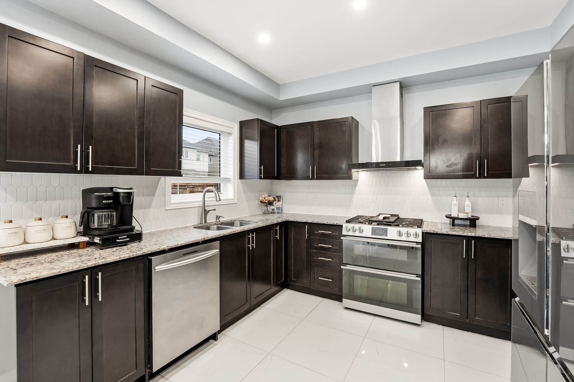 A Gas Range, A Picket Backsplash, And A Door To The Deck
