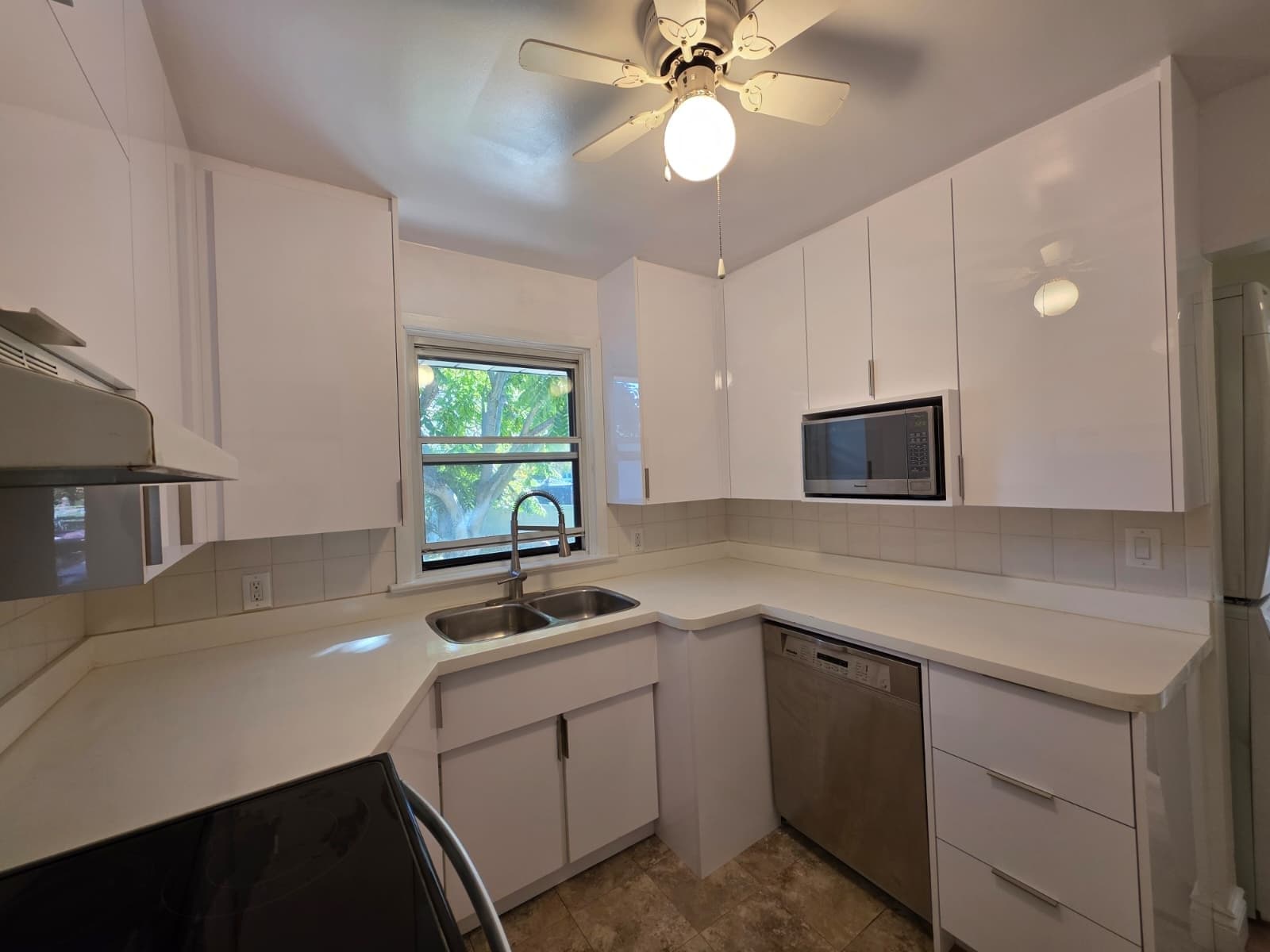 A Bright White Kitchen With A Dishwasher